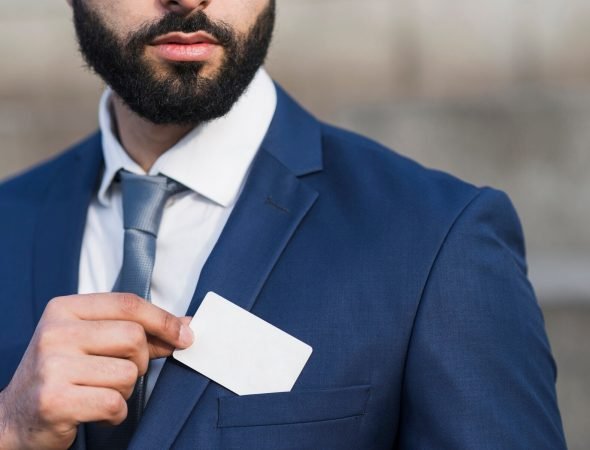 close-up-man-holding-business-card_23-2148479527